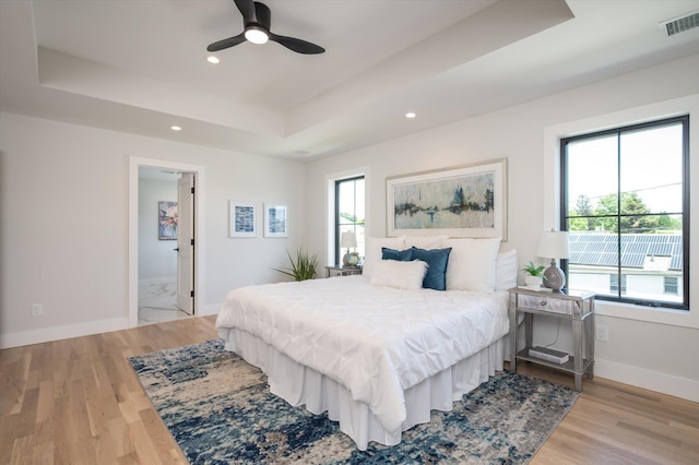 724 Pleasant Ave, Westbury, NY 11590 - bedroom with a tray ceiling, light wood finished floors, recessed lighting, and ceiling fan