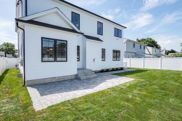 724 Pleasant Ave, Westbury, NY 11590 - back of property featuring a patio area and a fenced backyard