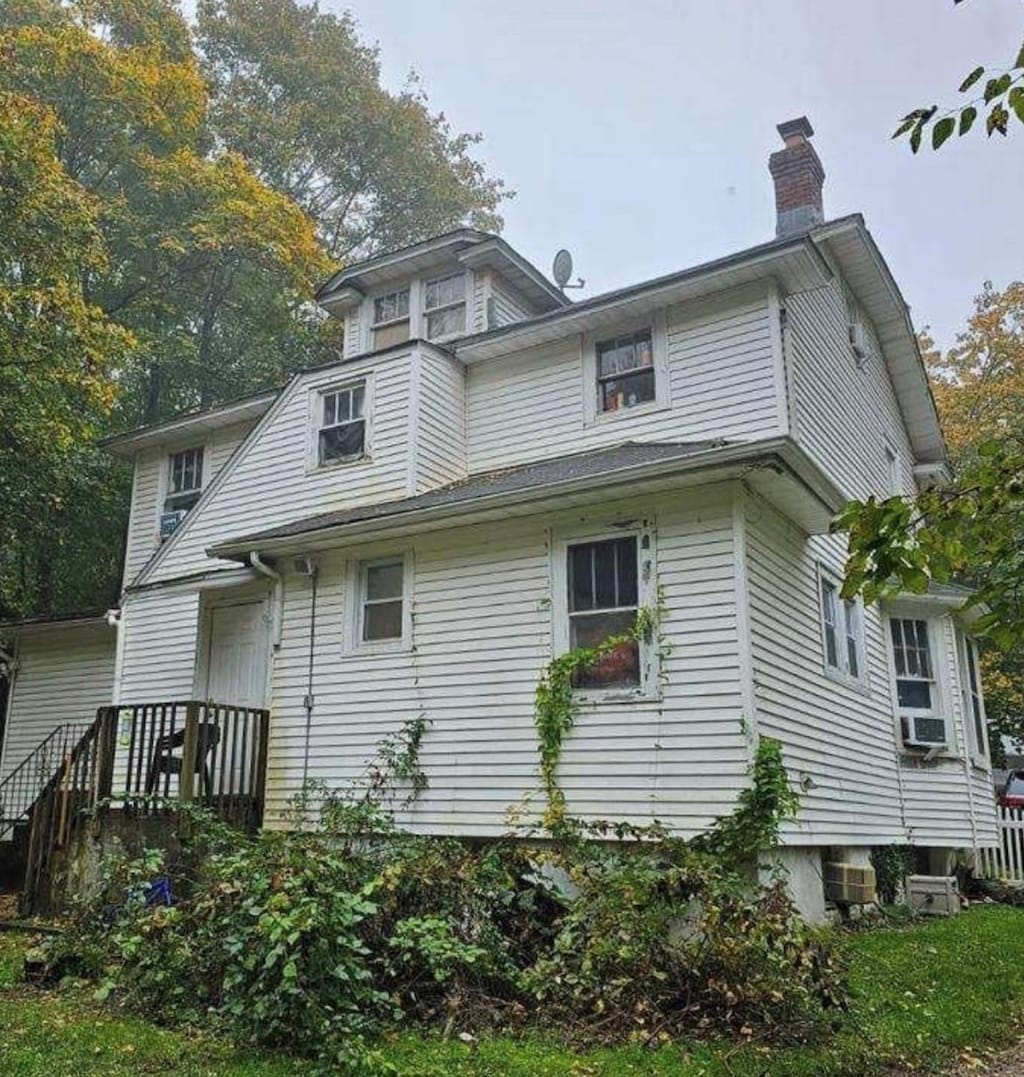 21 Old Portion Rd, Lake Ronkonkoma, NY 11779 - rear view of house with a chimney and cooling unit