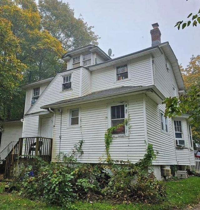 21 Old Portion Rd, Lake Ronkonkoma, NY 11779 - rear view of house with a chimney and cooling unit