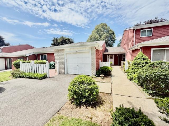 1104 Drew Dr, Saint James, NY 11780 - view of front of property with a garage, asphalt driveway, and brick siding