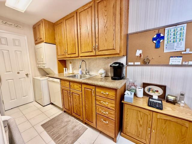 1104 Drew Dr, Saint James, NY 11780 - kitchen with white dishwasher, light tile patterned floors, tasteful backsplash, light countertops, and brown cabinetry