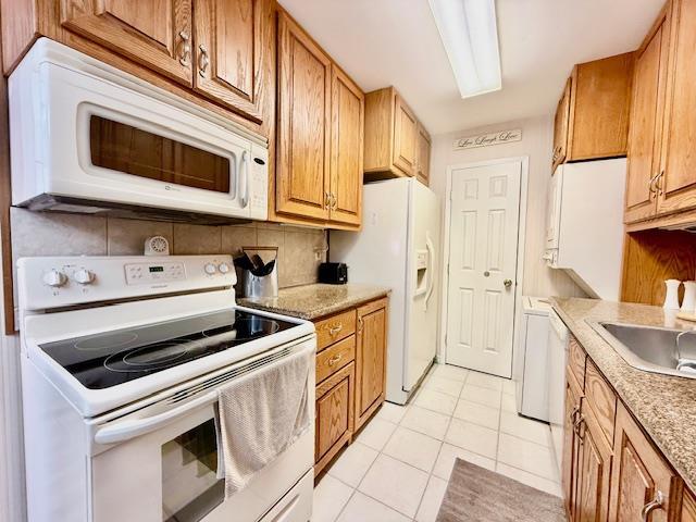 1104 Drew Dr, Saint James, NY 11780 - kitchen featuring white appliances, light tile patterned floors, light countertops, and decorative backsplash