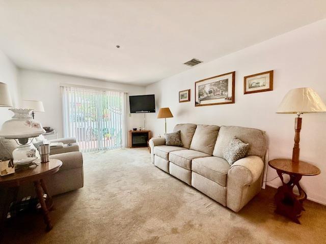 1104 Drew Dr, Saint James, NY 11780 - living area featuring carpet flooring