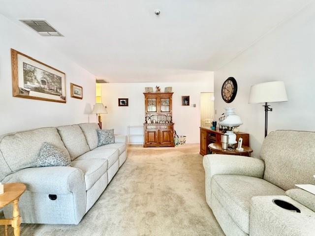 1104 Drew Dr, Saint James, NY 11780 - living area featuring light carpet