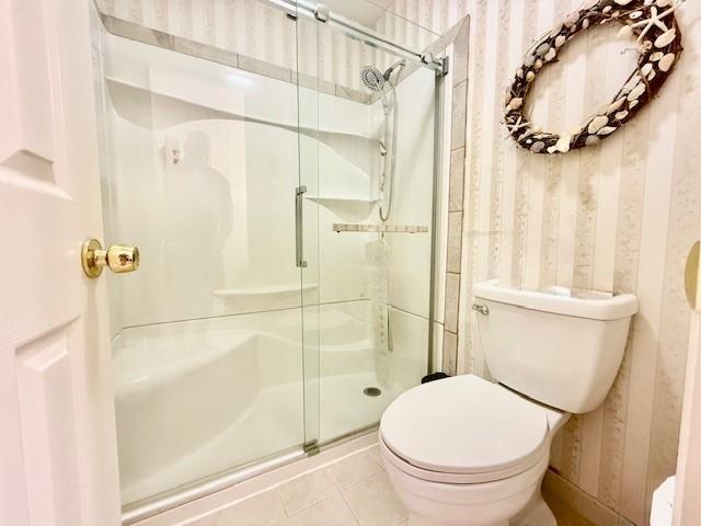 1104 Drew Dr, Saint James, NY 11780 - bathroom featuring a stall shower, tile patterned flooring, and wallpapered walls