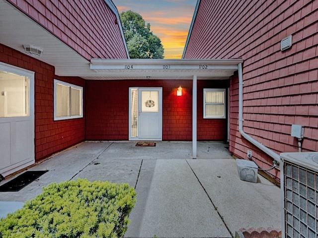 1104 Drew Dr, Saint James, NY 11780 - view of exterior entry featuring a patio