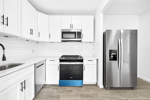 800 Brook Ave Unit 13B, Bronx, NY 10451 - kitchen featuring stainless steel appliances, light countertops, white cabinetry, and tasteful backsplash
