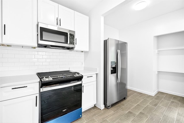 800 Brook Ave Unit 13B, Bronx, NY 10451 - kitchen featuring appliances with stainless steel finishes, light countertops, decorative backsplash, white cabinetry, and light wood-style floors