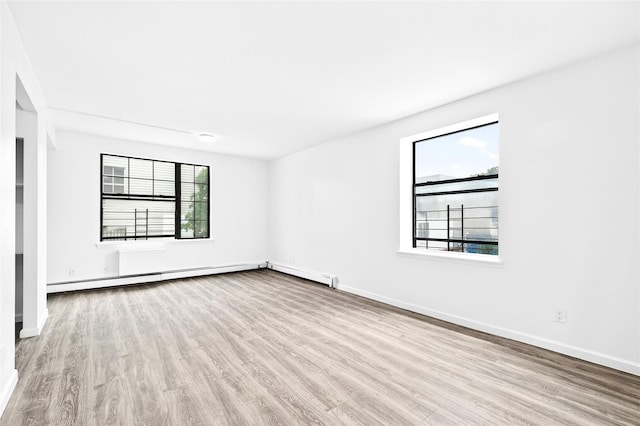 800 Brook Ave Unit 13B, Bronx, NY 10451 - spare room featuring wood finished floors and a baseboard heating unit