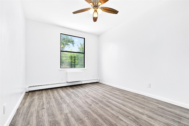 800 Brook Ave Unit 13B, Bronx, NY 10451 - spare room featuring a baseboard heating unit, wood finished floors, and a ceiling fan