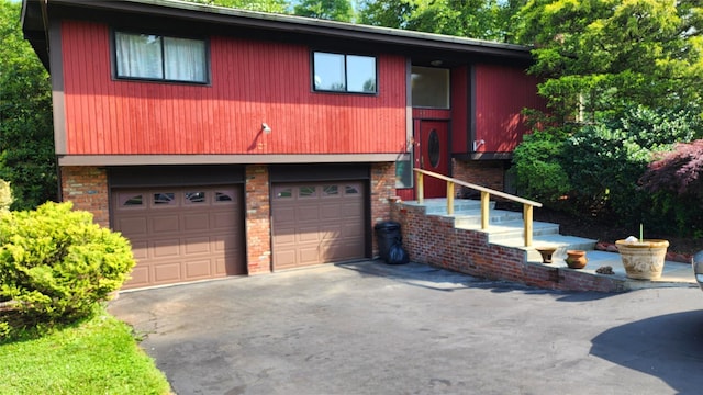 27 Maiden Ln, New City, NY 10956 - view of front facade featuring a garage, asphalt driveway, and brick siding