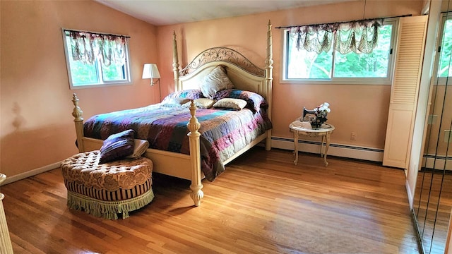 27 Maiden Ln, New City, NY 10956 - bedroom featuring a baseboard radiator, wood finished floors, multiple windows, and vaulted ceiling