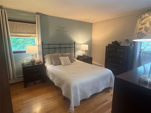 4 St Michaels Ln, Walden, NY 12586 - bedroom with wood finished floors and a baseboard heating unit