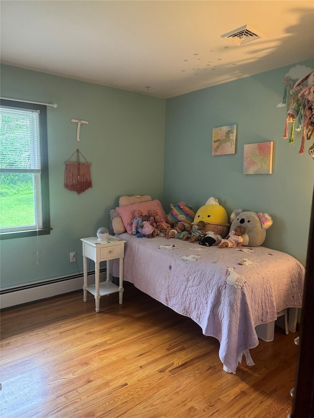 4 St Michaels Ln, Walden, NY 12586 - bedroom featuring wood finished floors and a baseboard heating unit