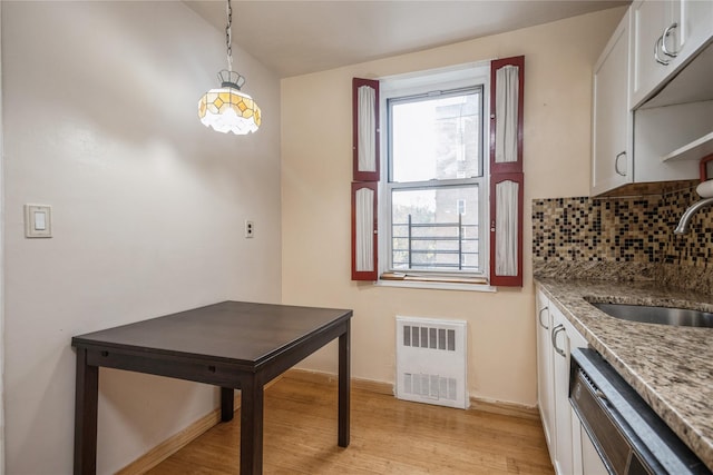 4 Sadore Ln Unit 3E, Yonkers, NY 10710 - kitchen featuring stainless steel dishwasher, radiator heating unit, decorative backsplash, and light wood finished floors