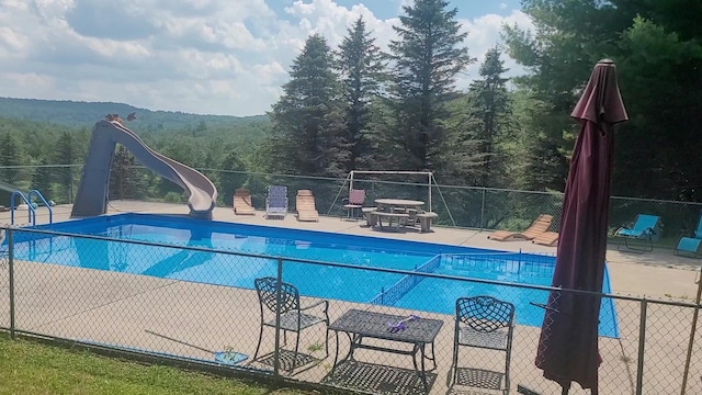 77 Krum, Hurleyville, NY 12747 - community pool featuring a water slide, a forest view, and a patio area