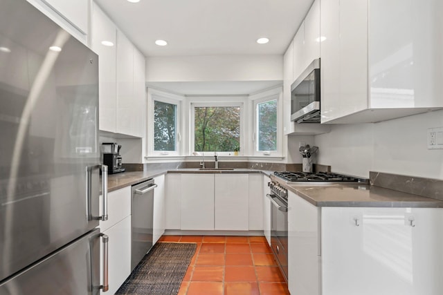 42 Valley Ave, Locust Valley, NY 11560 - kitchen with appliances with stainless steel finishes, white cabinetry, recessed lighting, dark countertops, and modern cabinets
