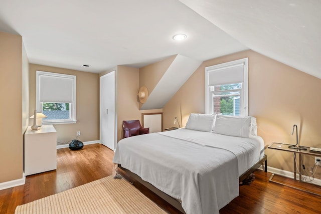 42 Valley Ave, Locust Valley, NY 11560 - bedroom with wood finished floors, multiple windows, and vaulted ceiling