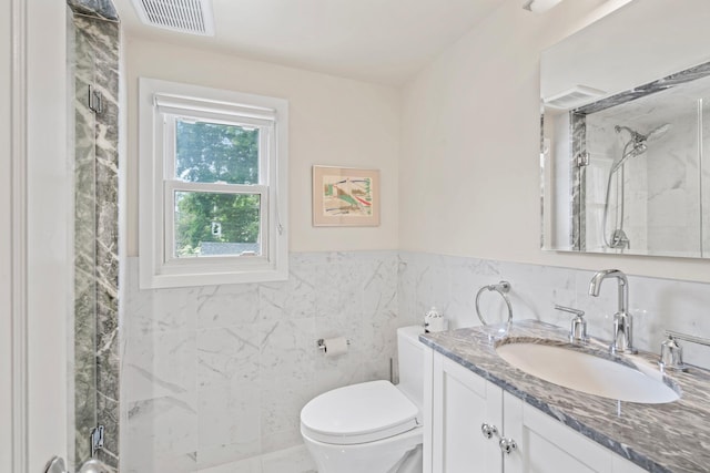 42 Valley Ave, Locust Valley, NY 11560 - bathroom featuring a shower stall, vanity, tile walls, and a wainscoted wall