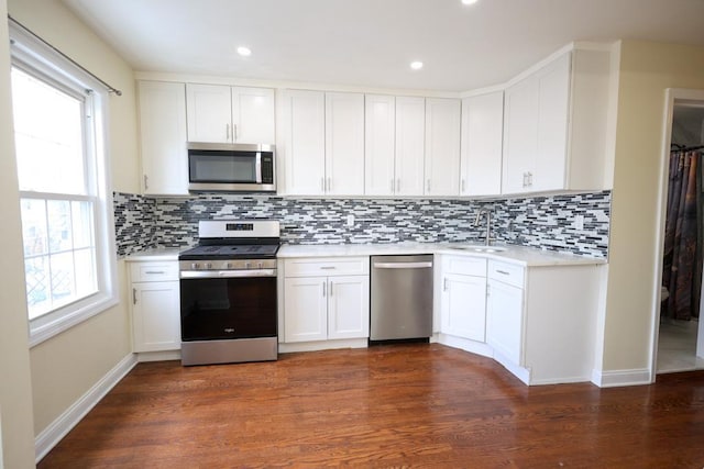10416 Rosita Rd, Ozone Park, NY 11417 - kitchen with stainless steel appliances, light countertops, decorative backsplash, white cabinetry, and recessed lighting