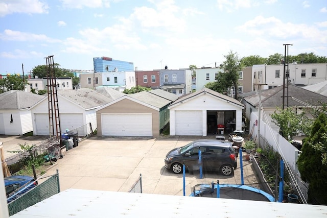 10416 Rosita Rd, Ozone Park, NY 11417 - townhome / multi-family property with a garage, a residential view, and an outdoor structure