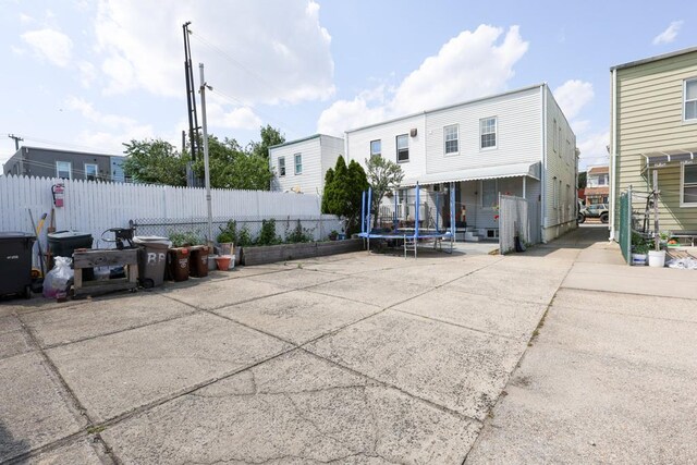 10416 Rosita Rd, Ozone Park, NY 11417 - back of property featuring a trampoline