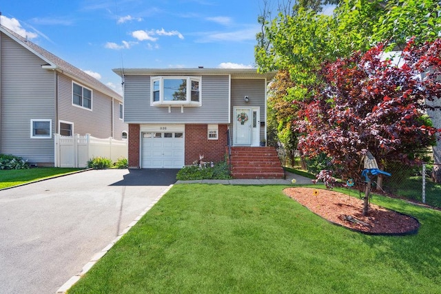 1126 Park Blvd, Massapequa Park, NY 11762 - view of front of house featuring brick siding, an attached garage, and driveway