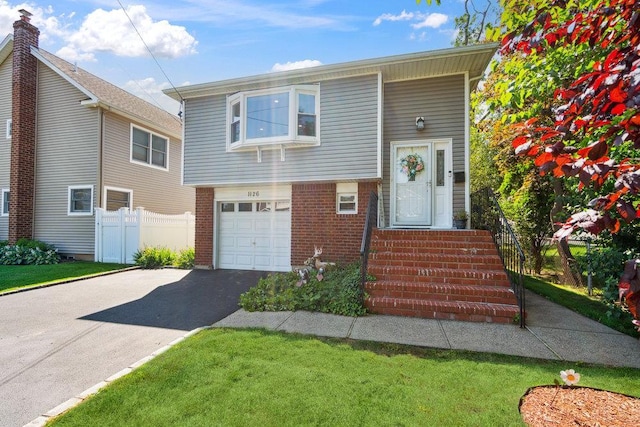 1126 Park Blvd, Massapequa Park, NY 11762 - view of front of home with an attached garage, brick siding, and asphalt driveway