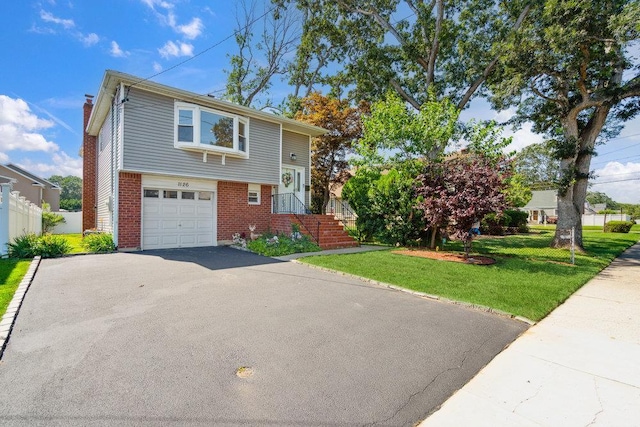 1126 Park Blvd, Massapequa Park, NY 11762 - view of front of home featuring driveway, brick siding, a chimney, and an attached garage