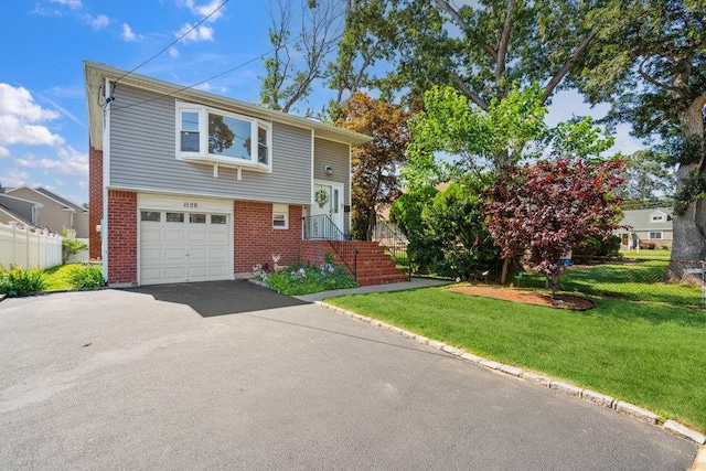 1126 Park Blvd, Massapequa Park, NY 11762 - view of front of property with brick siding, asphalt driveway, and an attached garage
