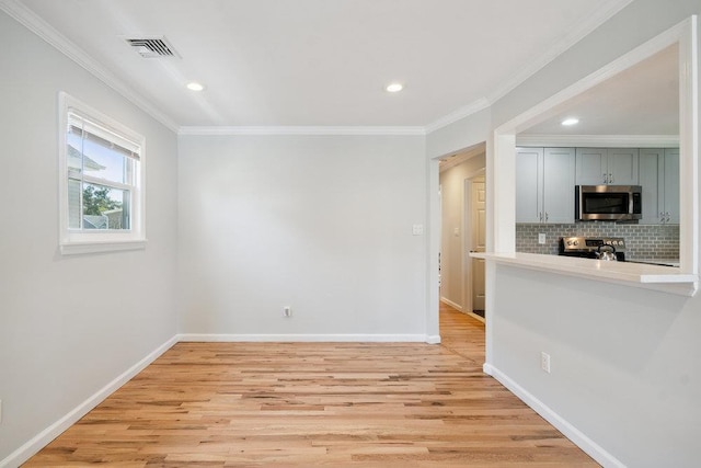 1126 Park Blvd, Massapequa Park, NY 11762 - kitchen with appliances with stainless steel finishes, decorative backsplash, light wood-style floors, recessed lighting, and crown molding