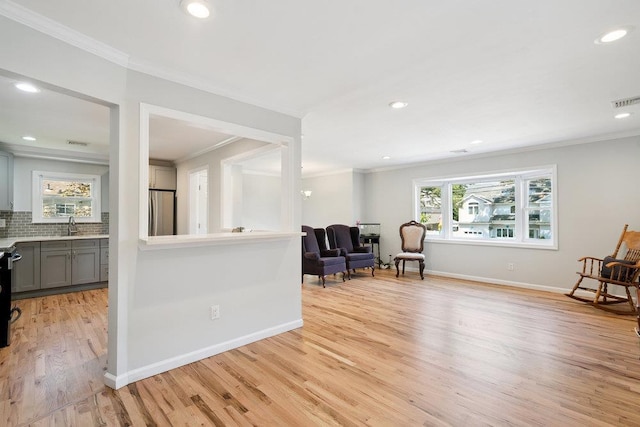 1126 Park Blvd, Massapequa Park, NY 11762 - sitting room featuring crown molding, light wood-type flooring, plenty of natural light, and recessed lighting