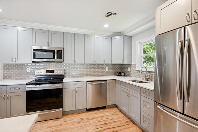 1126 Park Blvd, Massapequa Park, NY 11762 - kitchen featuring appliances with stainless steel finishes, gray cabinets, light countertops, decorative backsplash, and recessed lighting