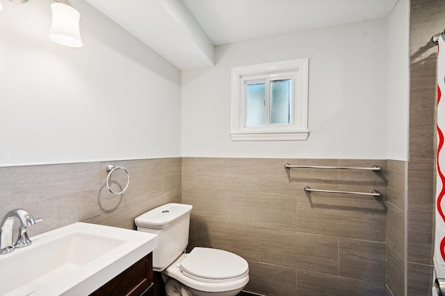 1126 Park Blvd, Massapequa Park, NY 11762 - full bathroom with tile walls, vanity, and wainscoting