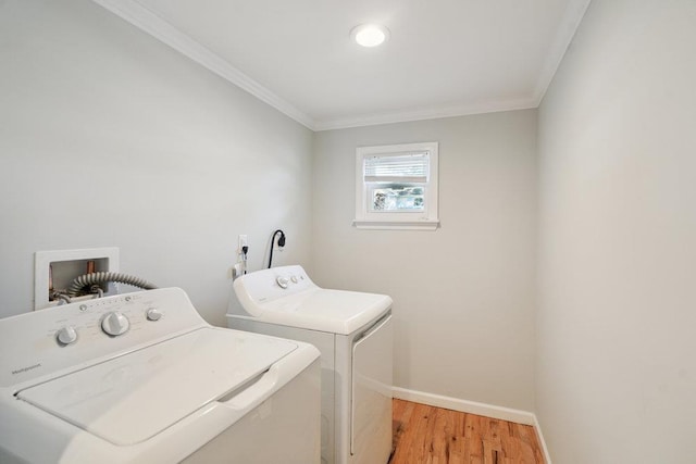 1126 Park Blvd, Massapequa Park, NY 11762 - washroom featuring washing machine and dryer, crown molding, and light wood-style flooring