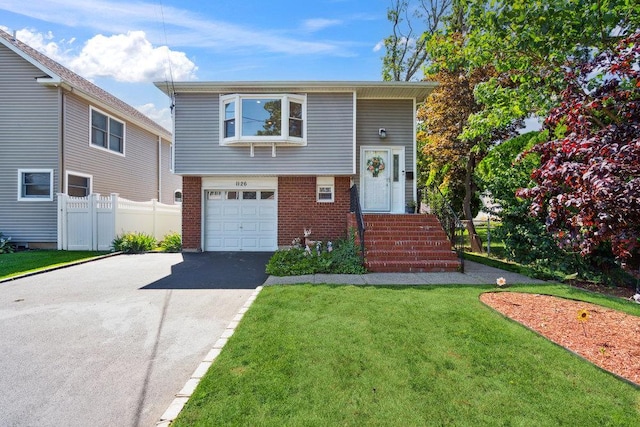 1126 Park Blvd, Massapequa Park, NY 11762 - view of front facade with brick siding, driveway, and a garage