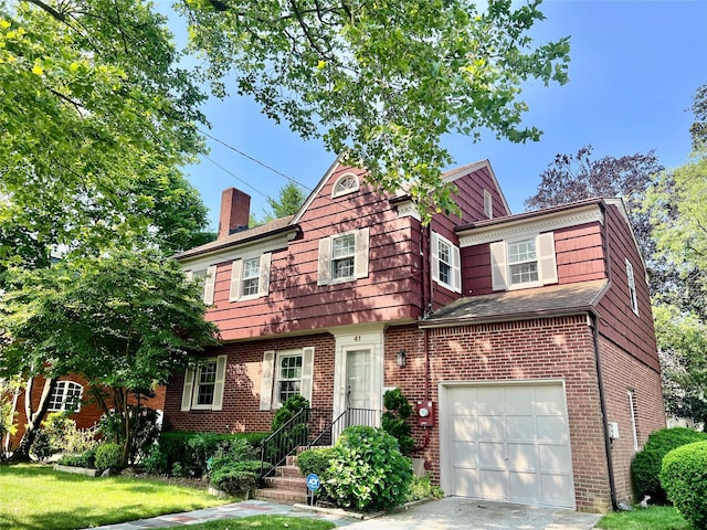 41 Derby Ave, Cedarhurst, NY 11516 - view of front of home with a garage, a chimney, a front yard, and brick siding