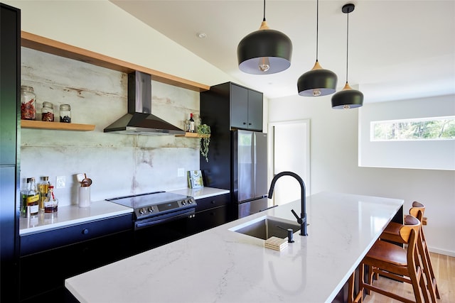 224 Upper Lumber Rd, Glen Spey, NY 12737 - kitchen with wall chimney exhaust hood, open shelves, appliances with stainless steel finishes, decorative light fixtures, and light wood finished floors