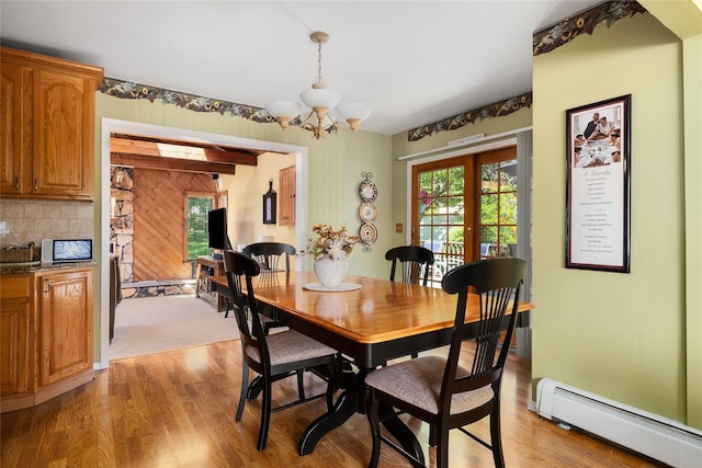 7 Garnet Ln, Plainview, NY 11803 - dining space with baseboard heating, a chandelier, and light wood-style flooring