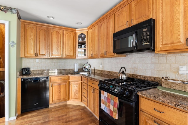 7 Garnet Ln, Plainview, NY 11803 - kitchen with black appliances, light wood-style flooring, dark stone countertops, and recessed lighting