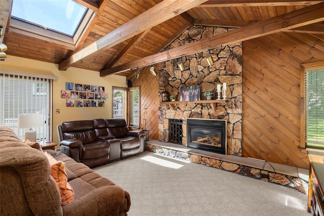 7 Garnet Ln, Plainview, NY 11803 - living area featuring a skylight, wood ceiling, a stone fireplace, carpet floors, and wooden walls