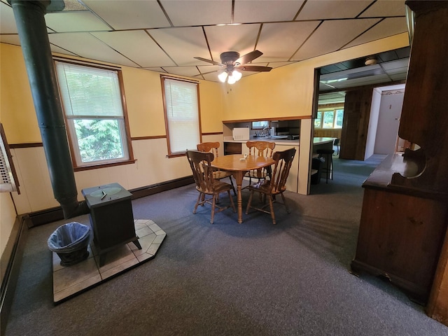 1485 Briscoe Rd, Swan Lake, NY 12783 - dining area featuring a wood stove, a baseboard radiator, healthy amount of natural light, and carpet floors