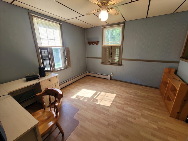 1485 Briscoe Rd, Swan Lake, NY 12783 - unfurnished office featuring light wood-type flooring, ceiling fan, a baseboard radiator, and wooden walls