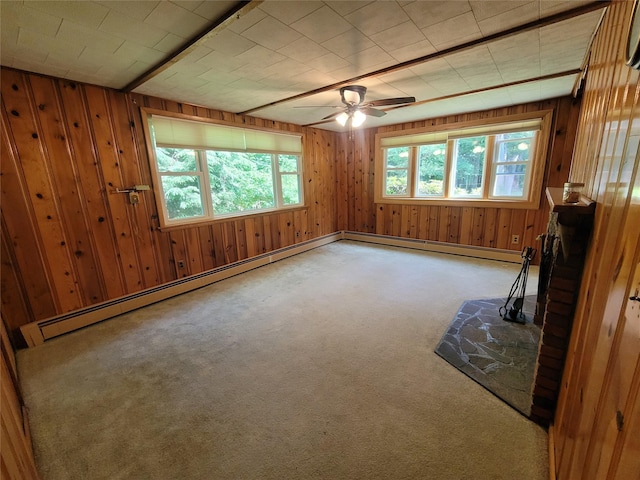 1485 Briscoe Rd, Swan Lake, NY 12783 - carpeted spare room featuring wood walls, a baseboard heating unit, and ceiling fan