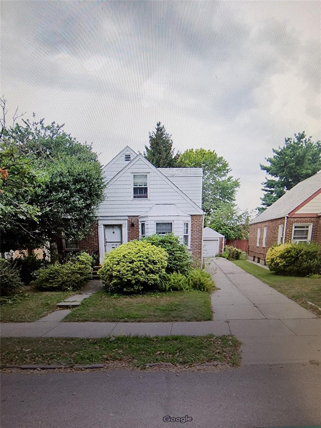 67-16 147th St, Kew Garden Hills, NY 11367 - view of front of home with a detached garage and brick siding
