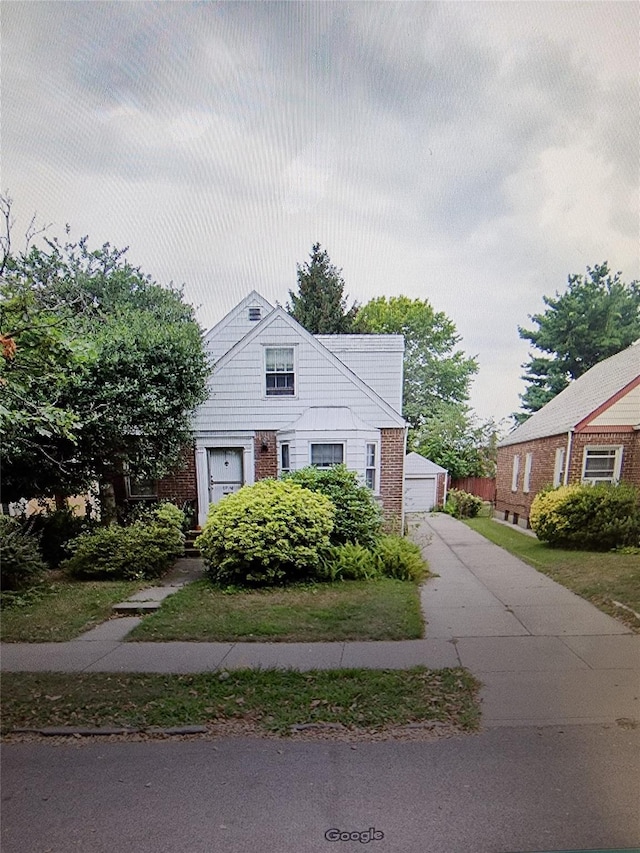 67-16 147th St, Kew Garden Hills, NY 11367 - view of front of home with a detached garage and brick siding