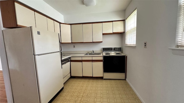 125 N Washington Ave Unit 46, Hartsdale, NY 10530 - kitchen featuring white appliances, light floors, light countertops, and cream cabinetry