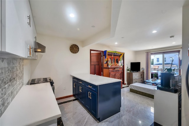 7425 43rd Ave Unit 2A, Elmhurst, NY 11373 - kitchen with blue cabinetry, a peninsula, light countertops, stainless steel gas range oven, and backsplash