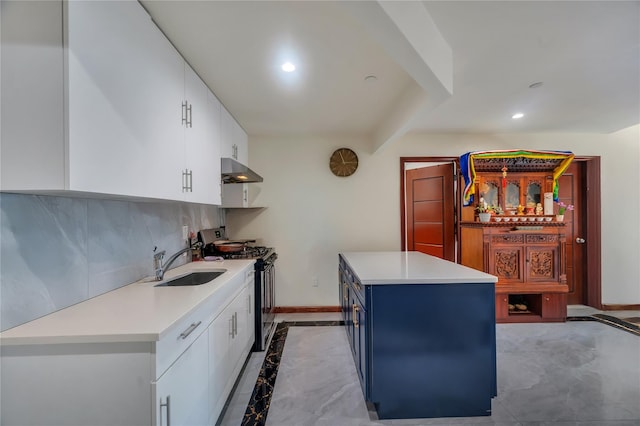 7425 43rd Ave Unit 2A, Elmhurst, NY 11373 - kitchen featuring stainless steel gas stove, under cabinet range hood, blue cabinets, light countertops, and white cabinets